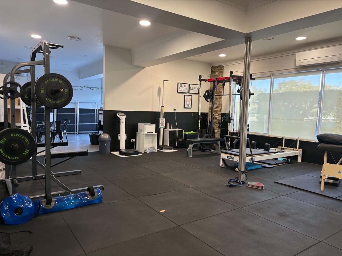 The Golf Fit Physio gym inside LIFT Physio at Helensvale — racks, a reformer and a treatment bed
